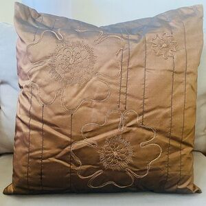 Brown silk decorative throw pillow with embroidered floral outlines